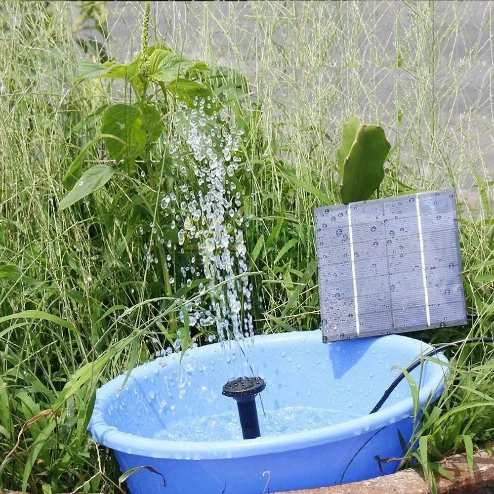Mini 1.2W solar fountain pump and solar panel set up in a small garden fountain – view 2